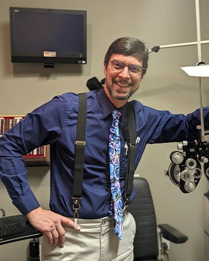 Eye Doctor Piqua OH David Littlejohn About HP Eye Doctor David Littlejohn Smiling In Suspenders With Optometry Equipment